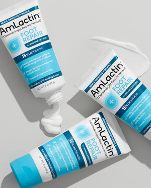 Trio of AmLactin Foot Repair Cream 3oz Tubes on light grey background. Two cream swatches below two tubes on image.