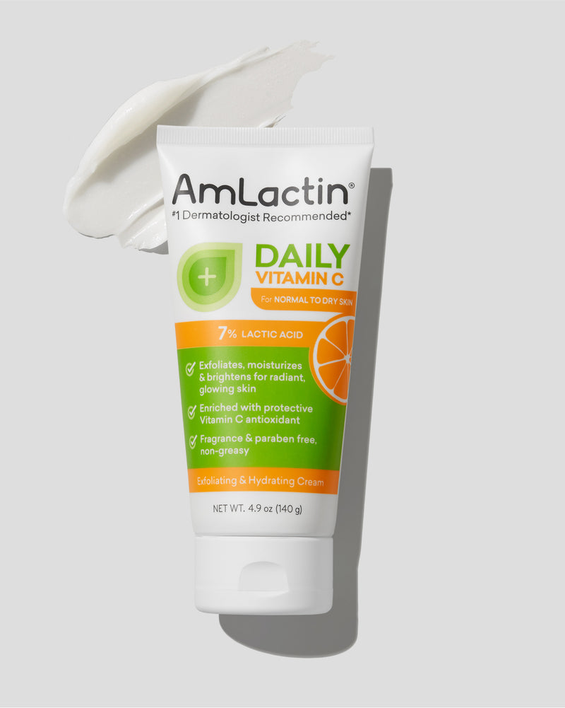 AmLactin Daily Vitamin C 7% Cream 4.9 oz Tube on light grey background. Cream swatch behind tube in top left corner of image.