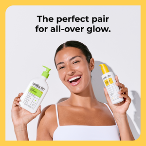 A smiling woman holds two Amlactin bottles, one with a green pump and one with a yellow cap, against a light gray background with a yellow border. Text at the top reads, 'The perfect pair for all-over glow.