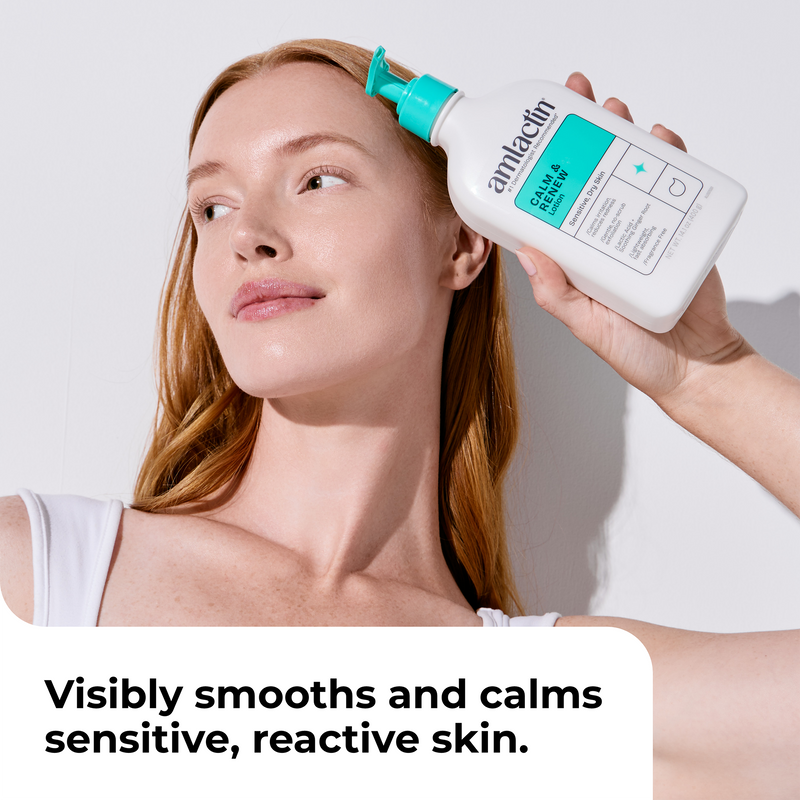 A woman with light skin and long strawberry-blonde hair holds a bottle of Amlactin Calm & Renew to her forehead. The bottle is white with a bright teal cap and label.