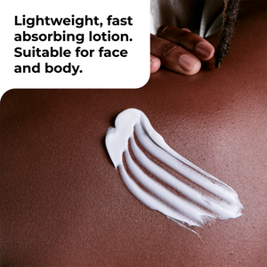 A close-up of white lotion swirled on a warm brown skin surface, with a hand holding a cleansing tool in the upper right and text reading 'Lightweight, fast absorbing lotion. Suitable for face and body.'