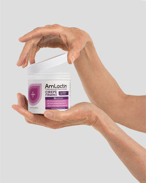 Older Female Hands Removing Lid of AmLactin Crepe Firming Cream