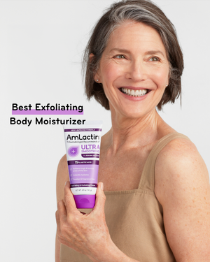 Grey-haired woman in tan tank top holding AmLactin Ultra Smoothing Cream tube. Shop Today 2023 Beauty Awards badge for Best Exfoliating Body Moisturizer
